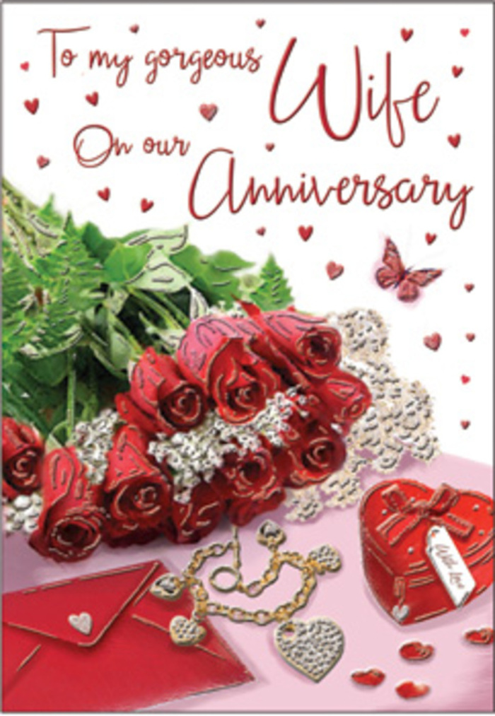 The image presents a romantic anniversary card styled with the intimacy of a private celebration at home in Canning Town, where love is expressed through small but meaningful details. Dominating the layout is a cluster of classic red roses, the blooms full and layered, each petal rich with velvety depth and a slight sheen that suggests they were freshly cut and carefully arranged. Surrounding the roses is a halo of lush greenery, leaves overlapping in gentle curves, their deep green colour adding both balance and a hint of nature's calm. Close to the flowers rests an envelope, poised as if ready to be slipped through a letterbox on a quiet street off Hermit Road, containing words that match the depth of the red petals. Beside it lies a dainty piece of jewellery-likely a necklace or chain-its metallic links shining softly, leading the eye toward a small heart-shaped box that hints at hidden treasures and shared history. Scattered around the central composition are miniature hearts and glimmering decorative details, like confetti from an anniversary dinner at home. A single butterfly motif drifts nearby, bringing a sense of movement and lightness, as if caught mid-flight. The lighting is diffused and flattering, casting gentle shadows and creating a sense of calm, intimate space. Every texture-from the smooth surface of the box to the soft folds of the envelope-has been chosen to echo the warmth of long-lasting love, making this design feel both timeless and rooted in the quiet rhythms of everyday life in Canning Town.