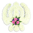 A dignified Sikh Khanda floral tribute is showcased against a clean white background, its sacred form defined entirely by a blanket of white blossoms. The central upright sword, surrounding chakkar ring, and the two curving kirpans that extend to either side are all sculpted from numerous small chrysanthemum heads, arranged so densely that they create a smooth, plush surface, like a soft embroidered emblem made of petals. The flowers are a creamy, serene white, their ruffled textures catching subtle highlights and giving the symbol a three-dimensional presence. Positioned at the base, where the blades intersect, a vivid accent posy draws the eye and adds emotional warmth. Three pink roses, open yet still firm at the edges, rest at the heart of this cluster, surrounded by a halo of smaller, deep purple flowers that deepen the overall tone while keeping the mood respectful and calm. Sprays of fresh green fern and foliage peep out from beneath, their shapes gently softening the strong lines of the Khanda and hinting at the scent of newly cut greenery. The composition feels carefully balanced and thoughtfully planned, capturing the tradition and devotion central to Sikh funeral customs. It is easy to imagine this tribute being delivered to a service in Canning Town, perhaps for a family gathering near the busy life of Barking Road yet seeking a moment of quiet remembrance. The soft shadow beneath the arrangement grounds it, making the floral Khanda appear solid and reassuring, a floral expression of faith, love, and farewell.
